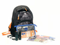 A backpack and its contents: binoculars, field guides, and a pass to enter Colorado State Parks.