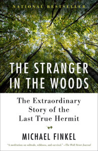A canopy of trees as the background photo for the book cover of The Stranger in the Woods by Michael Finkel