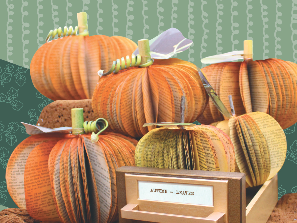 A photo of pumpkins made out of old books with a background of stylized phone cords.